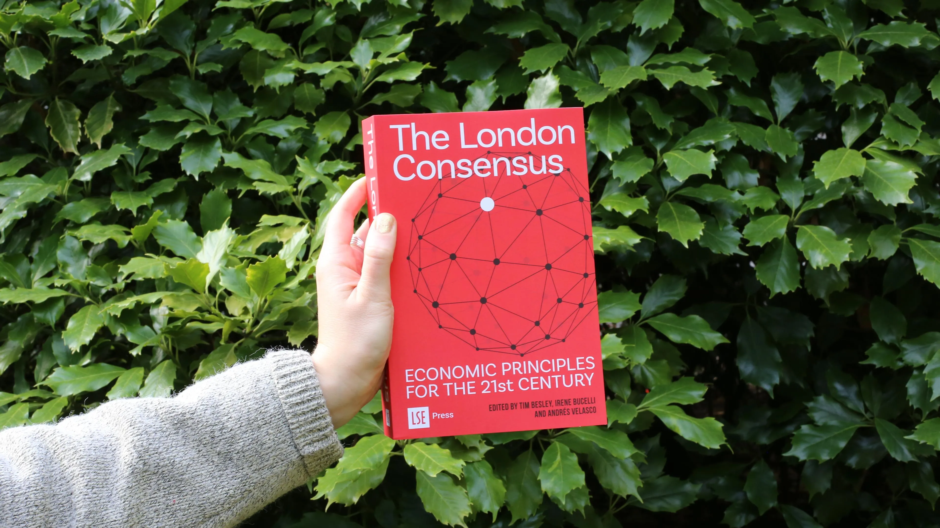 Hand holding The London Consensus book