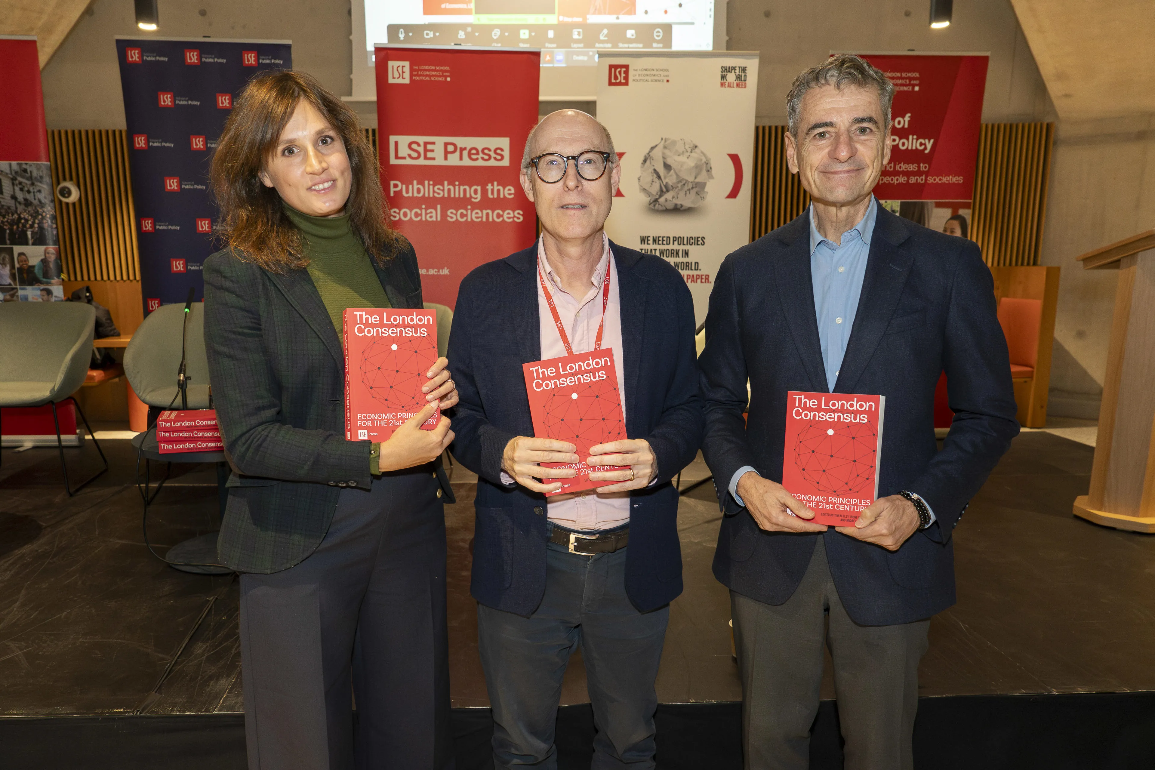 Irene Bucelli, Tim Besley, Andres Velasco holding The London Consensus books