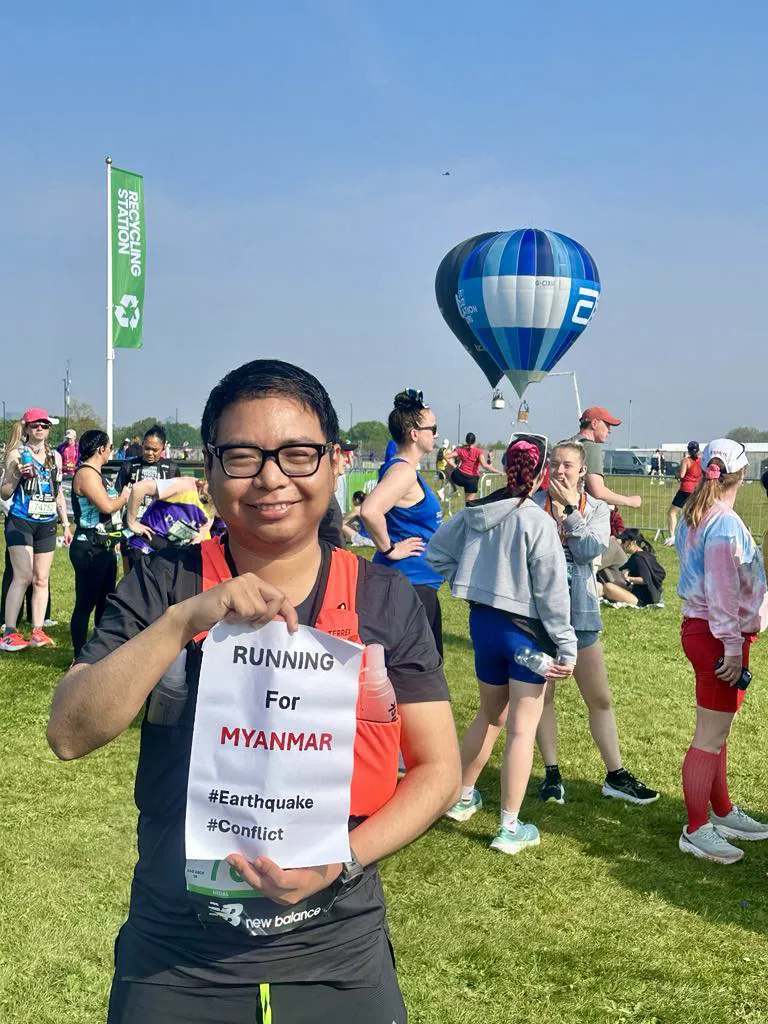 Nay Lin Tun at London Marathon holding up Running for Myanmar sign 