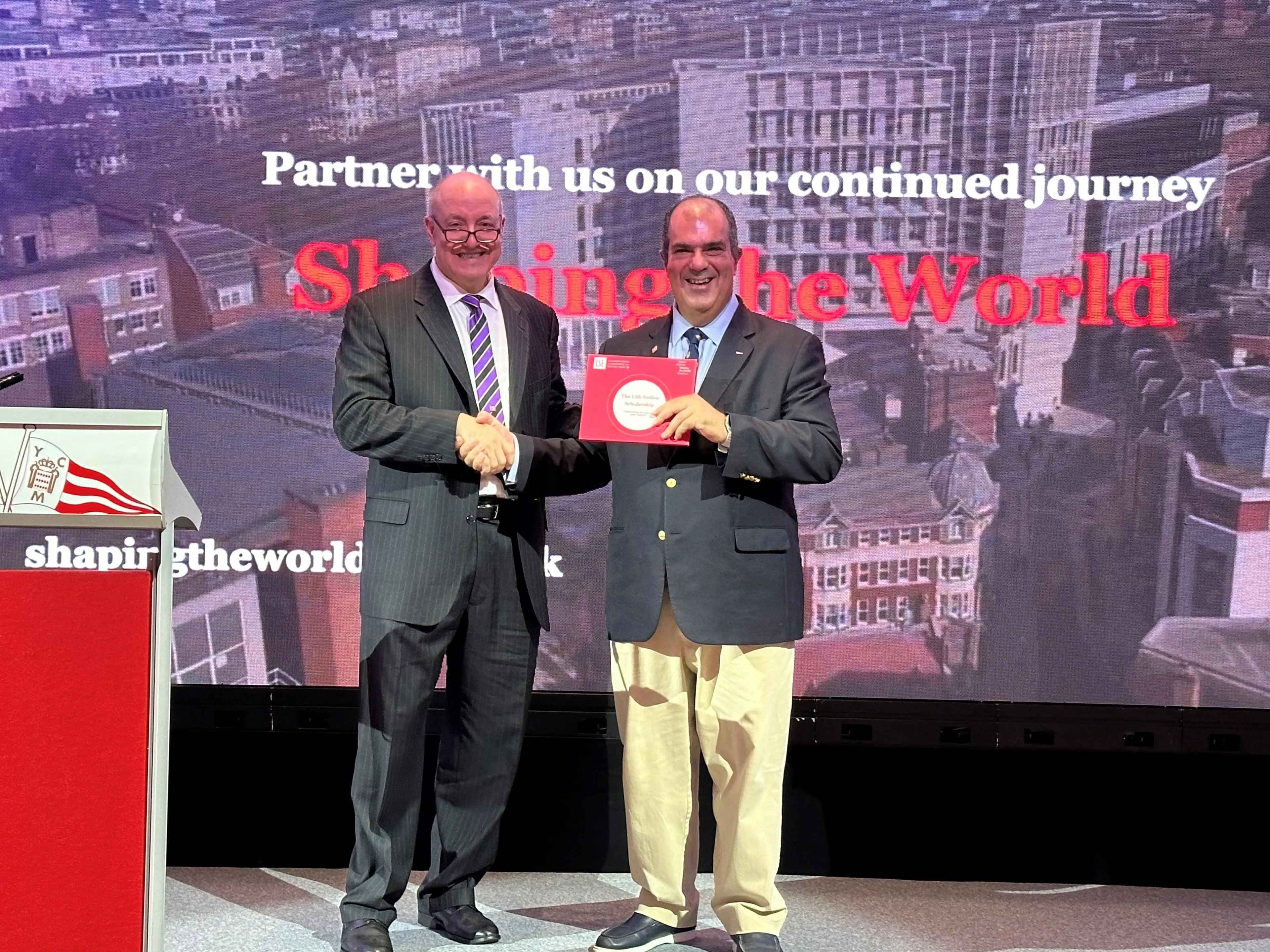 Sir Stelios being presented with the photobook at the event. 